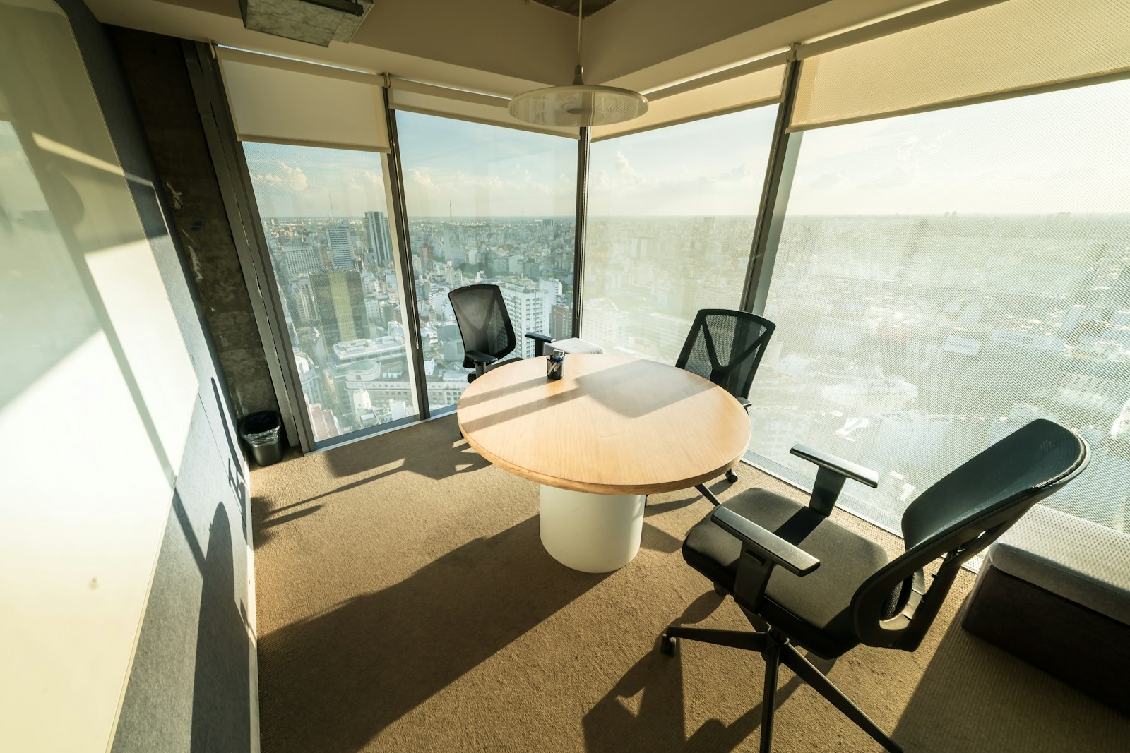 Modern executive boardroom with panoramic city skyline view, representing family office governance and investment committee decision making