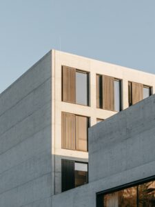 Family office investment strategies 2026: minimalist gray concrete high-rise building against a clear blue sky, representing institutional-grade wealth architecture