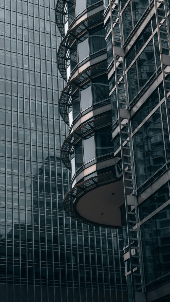 Minimalist glass skyscraper architecture representing HNI real estate net worth allocation in India