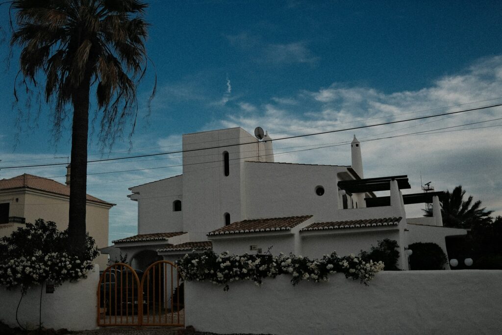 White minimalist coastal villa with clean architectural lines against a clear sky, an example of the quiet luxury aesthetic favored by ultra-high-net-worth families