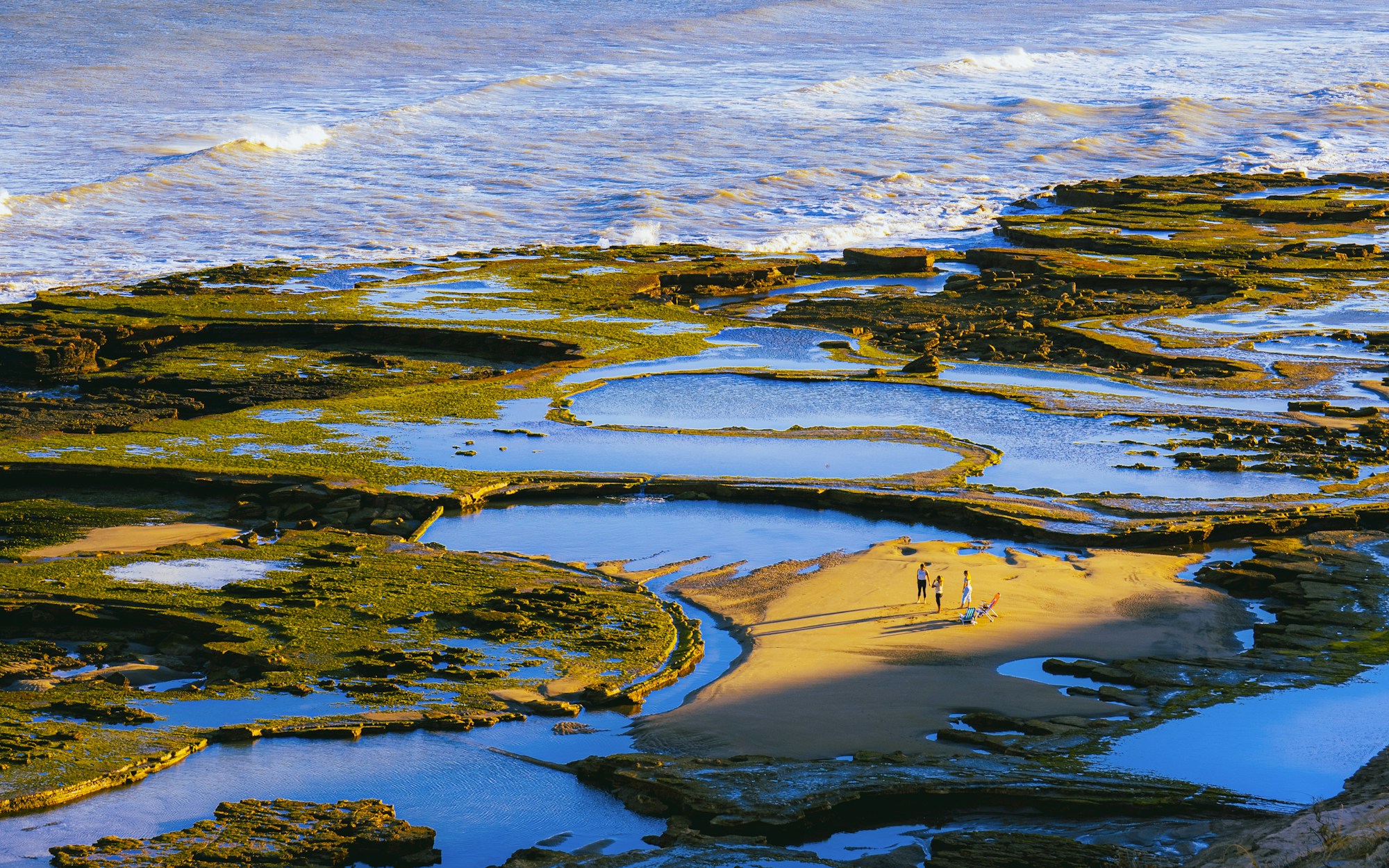 Rocky coastline with tide pools marking the high tide line used to measure Coastal Regulation Zone setback distances